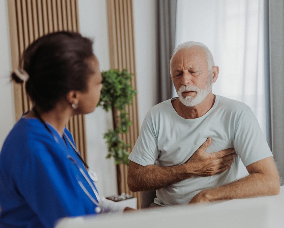 Old man speaking to healthcare worker