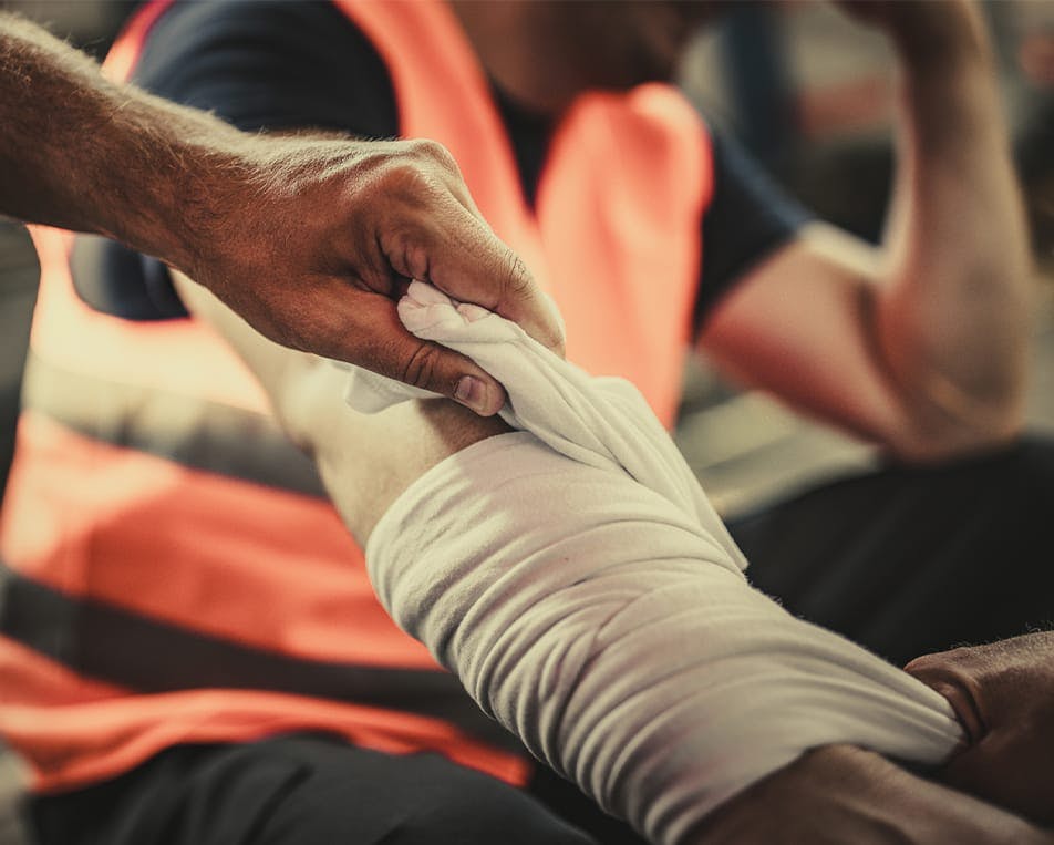 Person's arm being bandaged
