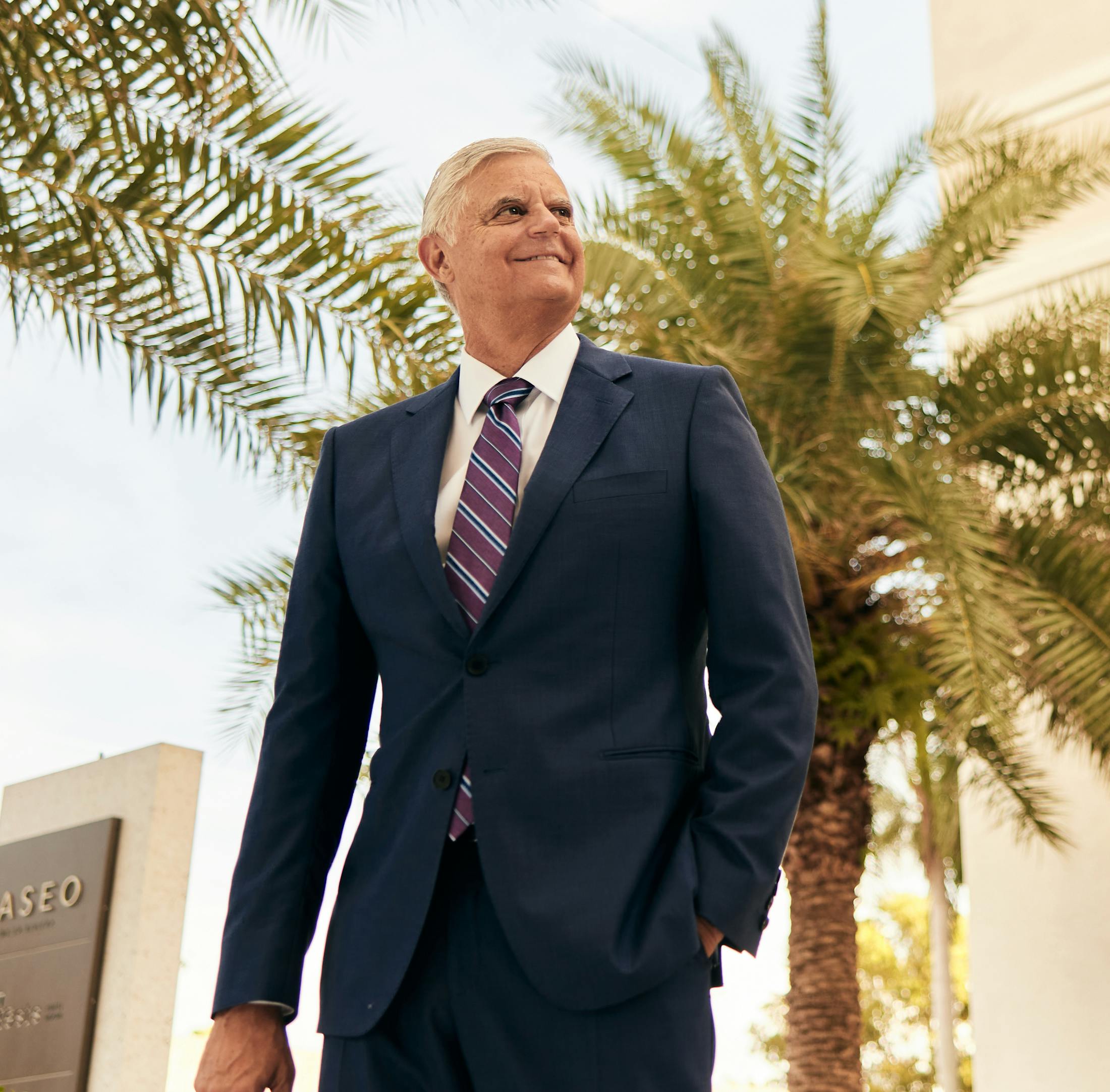Mr. Alvarez in his suit standing outside