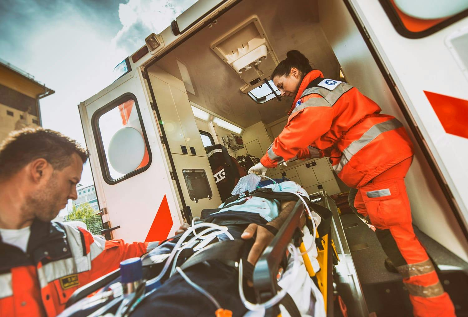 First-aid responders helping person