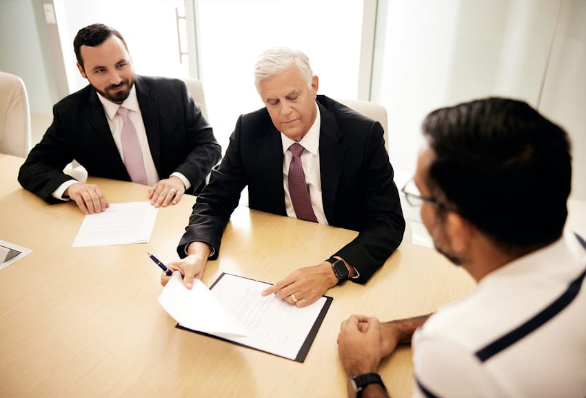 Attorneys at The Alvarez Law Firm speaking to client