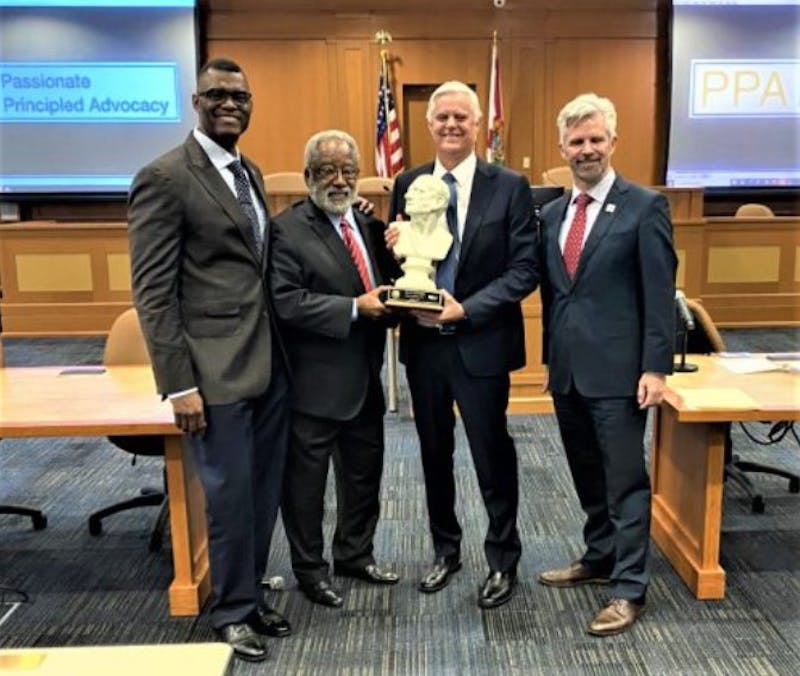 Alex Alvarez presents award at FIU College of Law