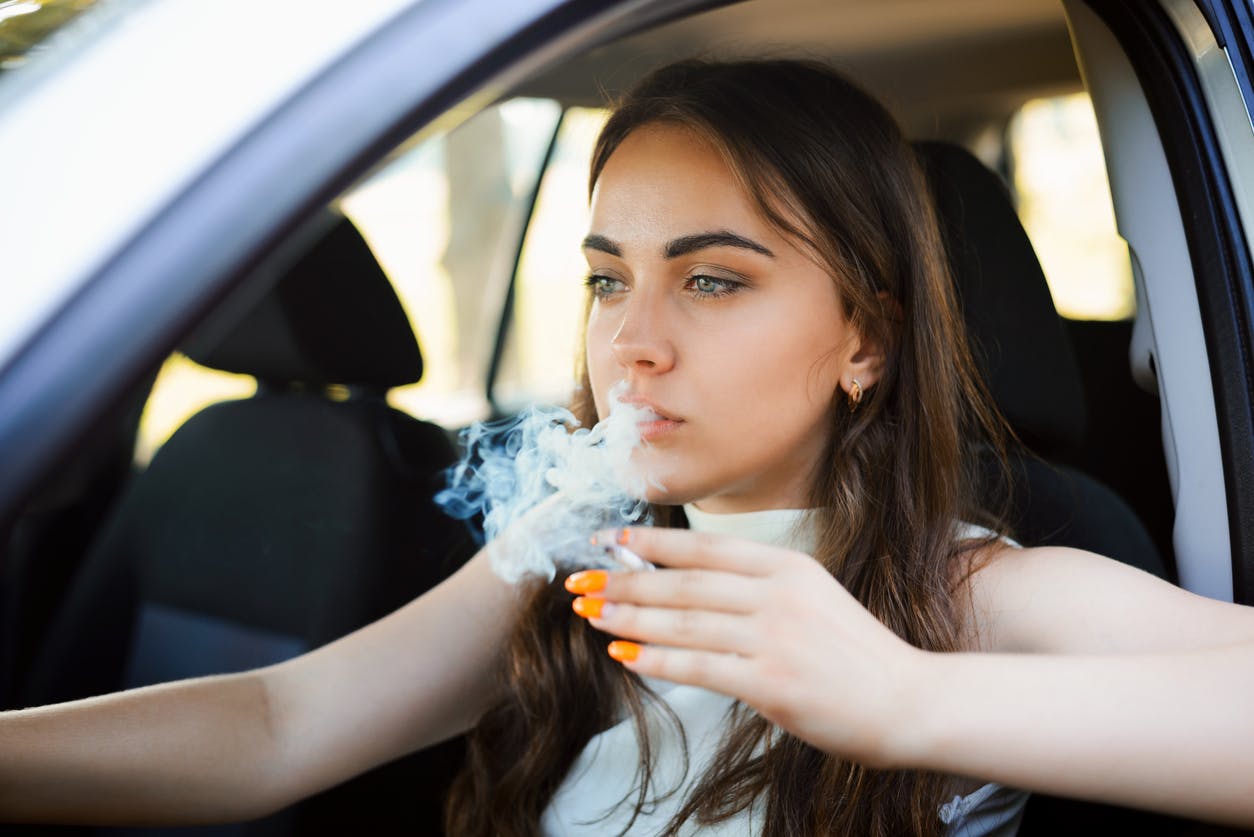 Woman smoking in a car