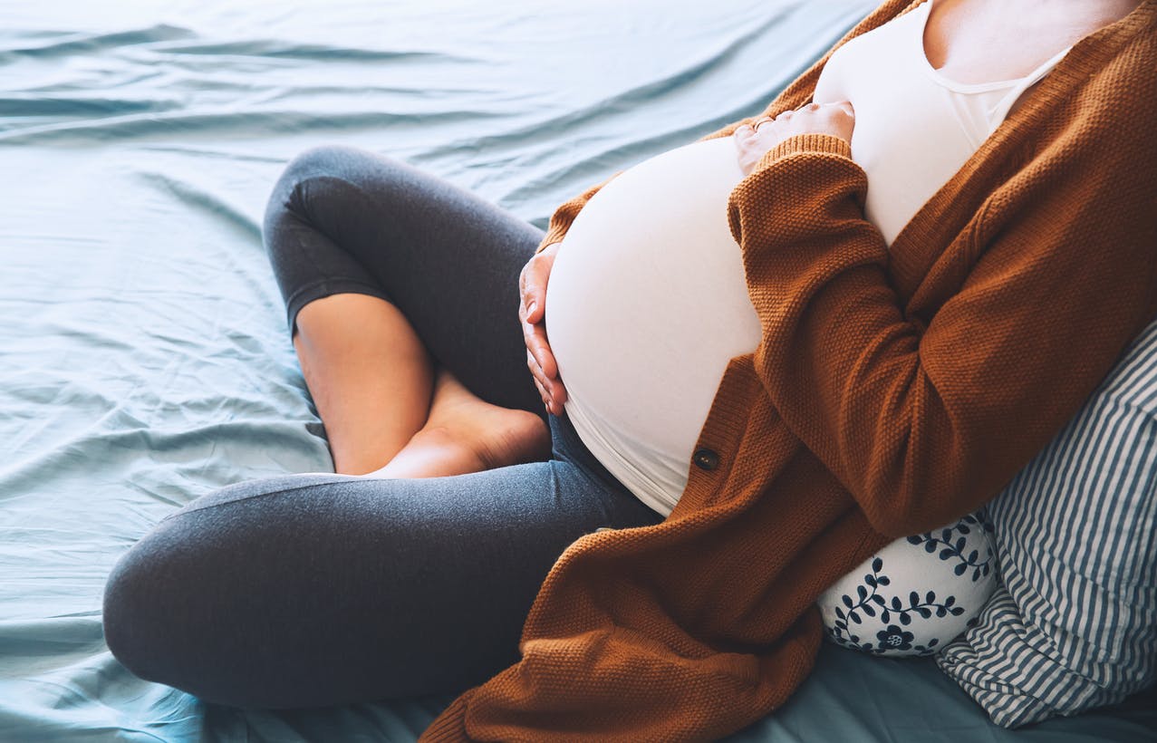 Pregnant woman holding her stomach