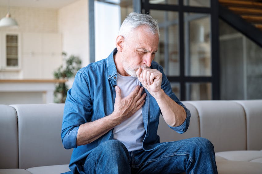 A man coughing