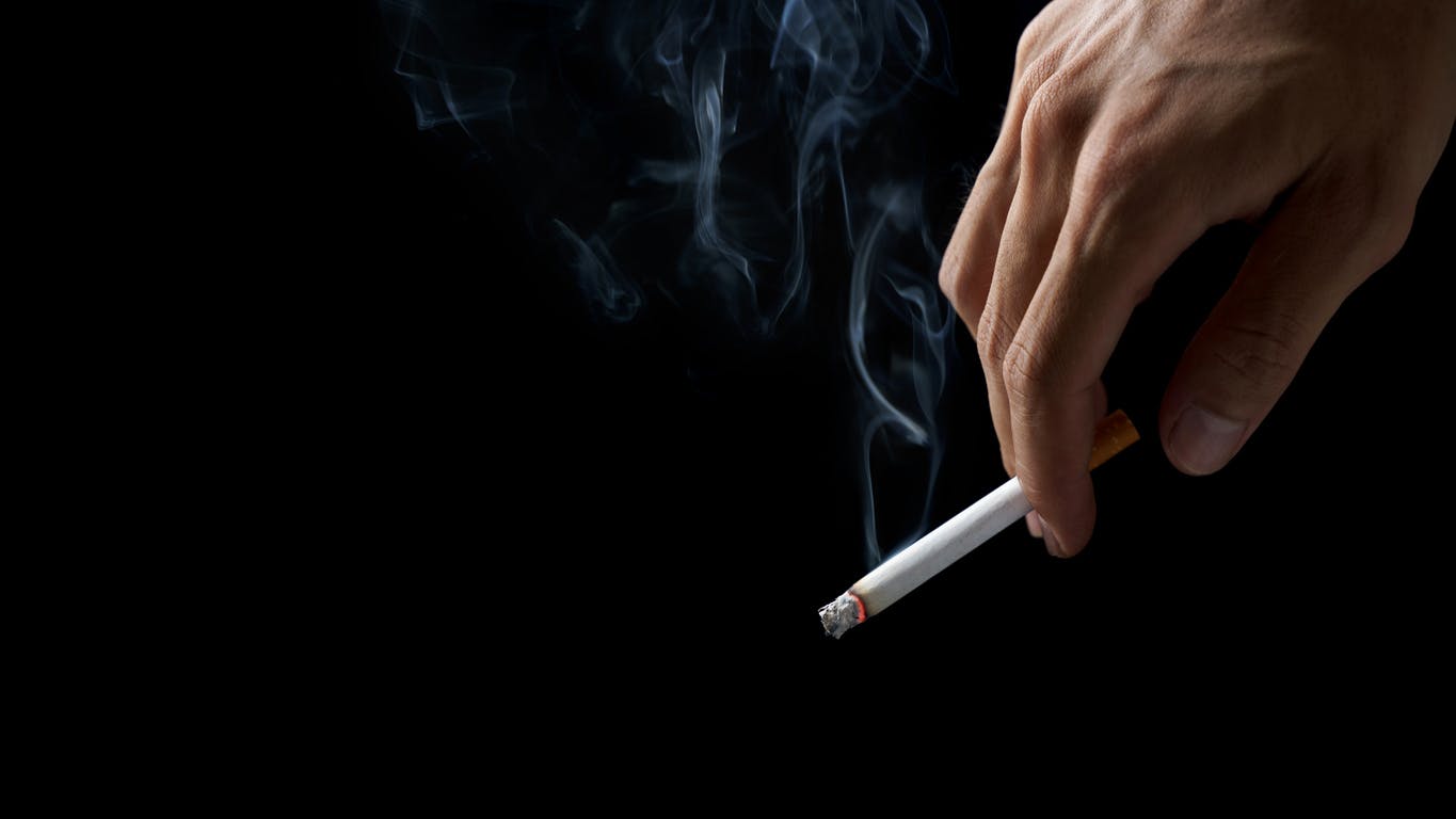 A hand holding a cigarette