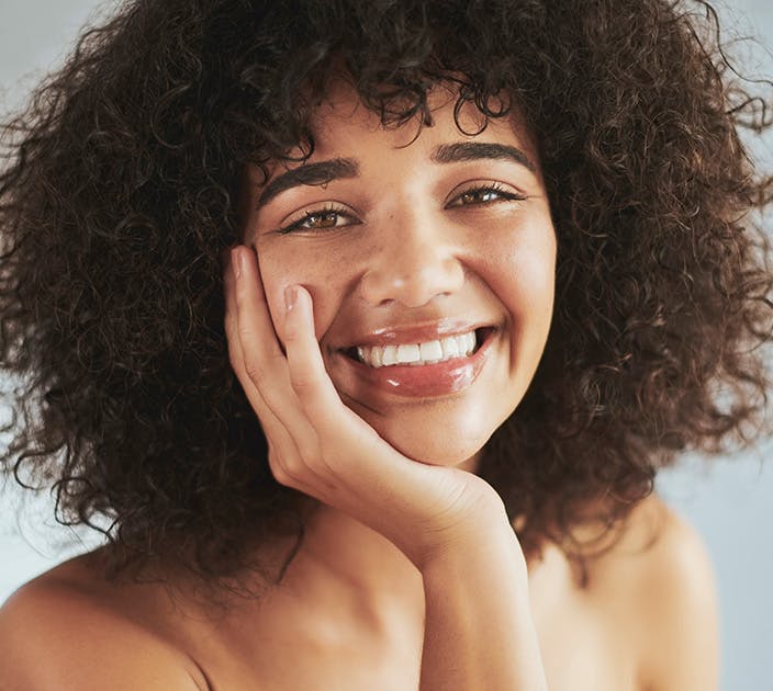 Woman Smiling with Hyperpigmentation