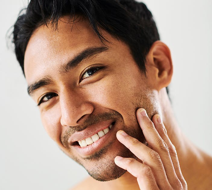 Male Rubbing Face Showing skin tone