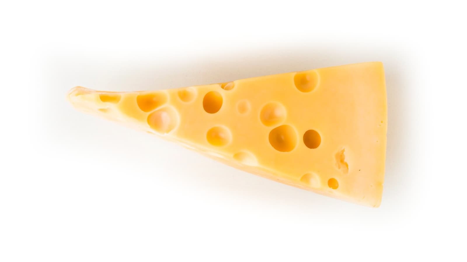 Ein Stück löchriger Käse auf einem weißen Boden.