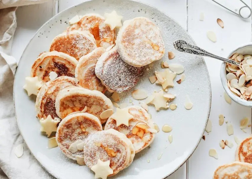 Pancakes und Zimtsterne auf einem Teller.