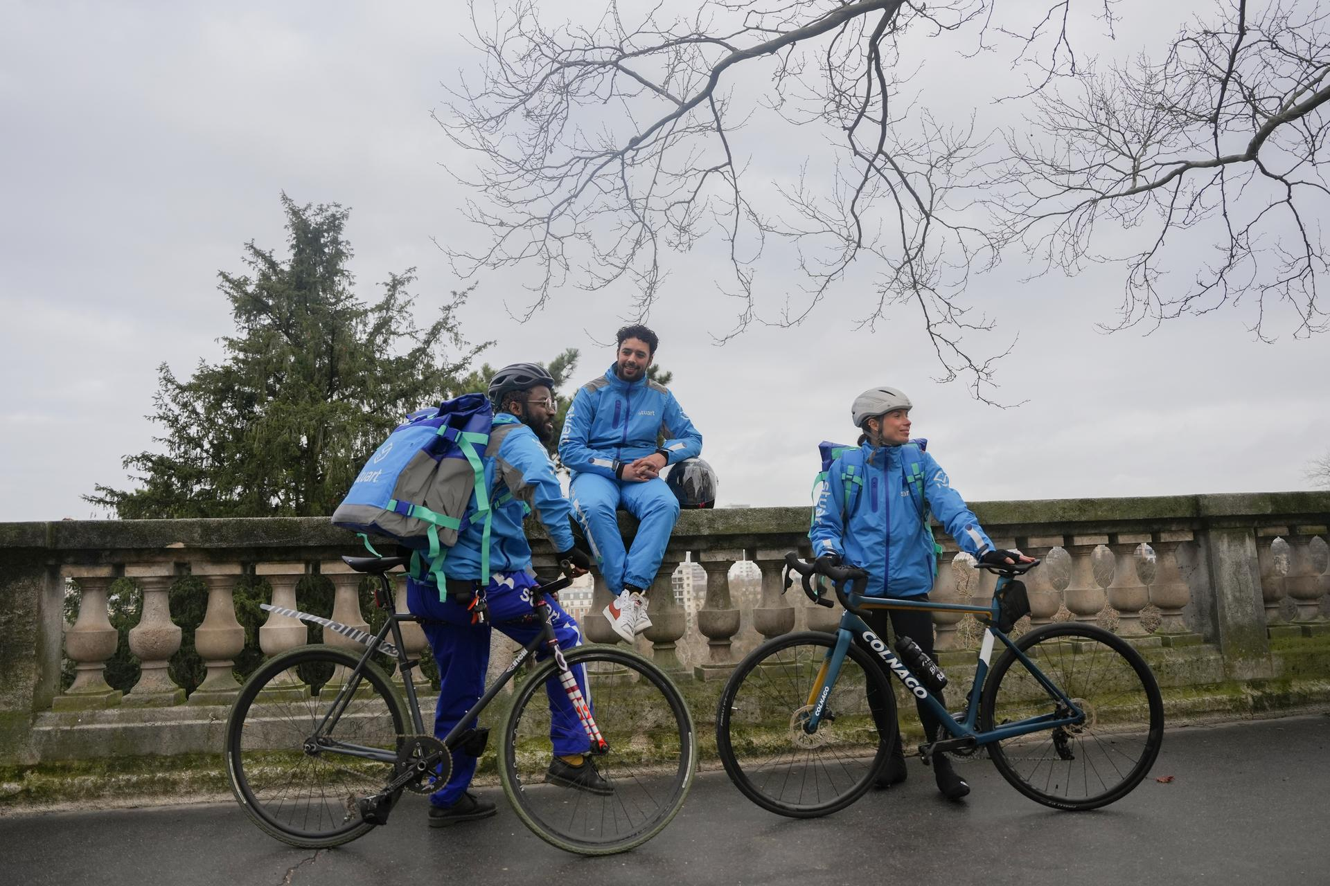 3 persons on a bridge riding bikes