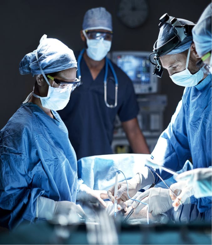Group of docotors performing a surgery.