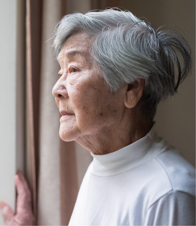 older woman looking out a window.