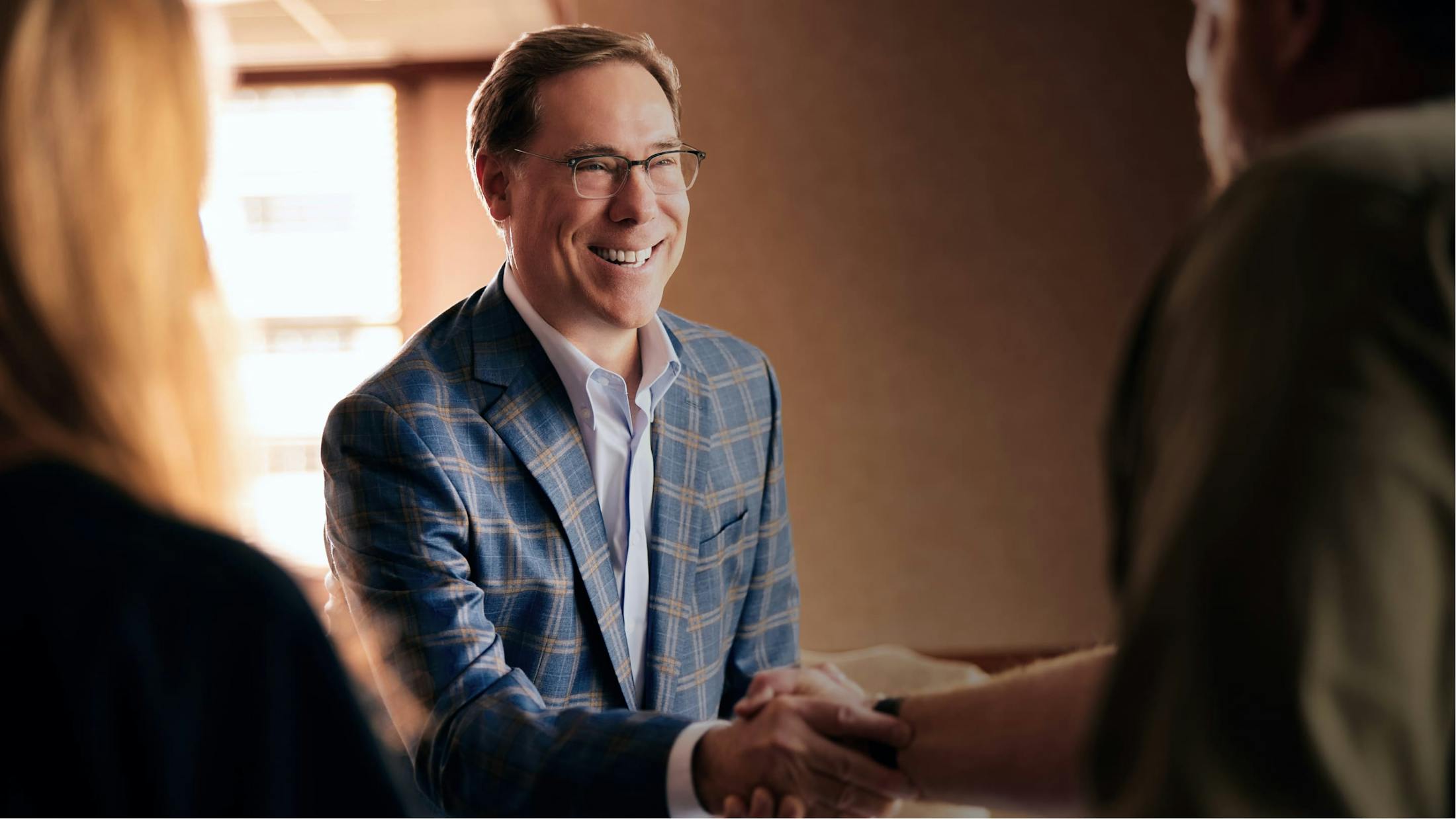Glenn W. Cunningham, a medical malpractice lawyer in San Antonio shaking someones hand