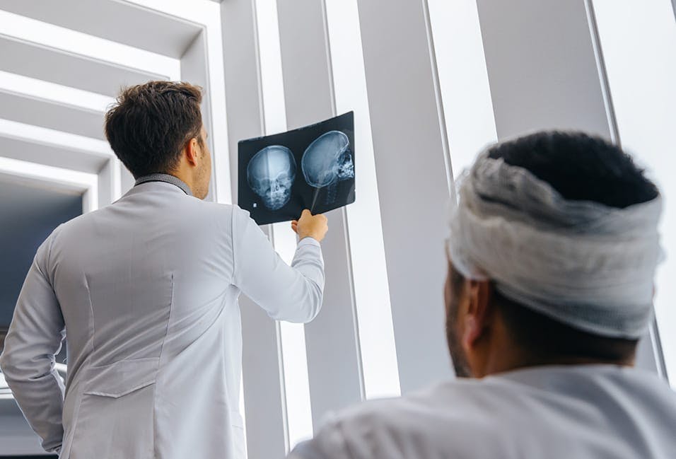 Doctor looking at a scan of someone's injured head