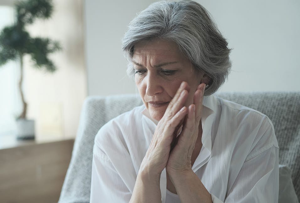 upset woman sitting in a chair