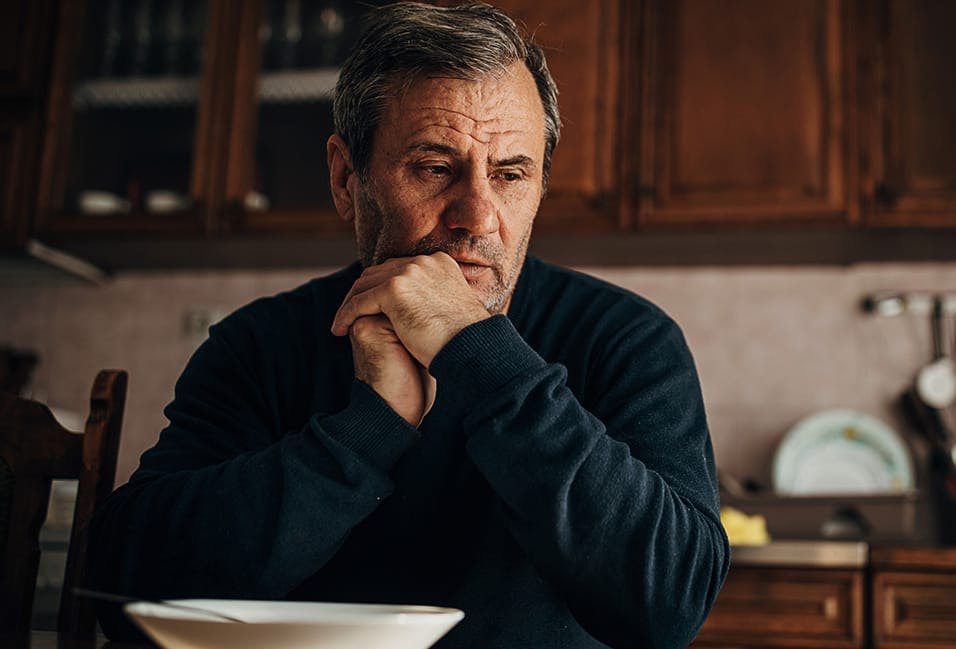 man looking not so good at the dinner table