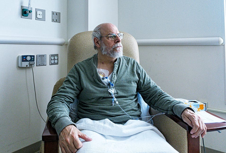 Man sitting in a chair connected to medical devices