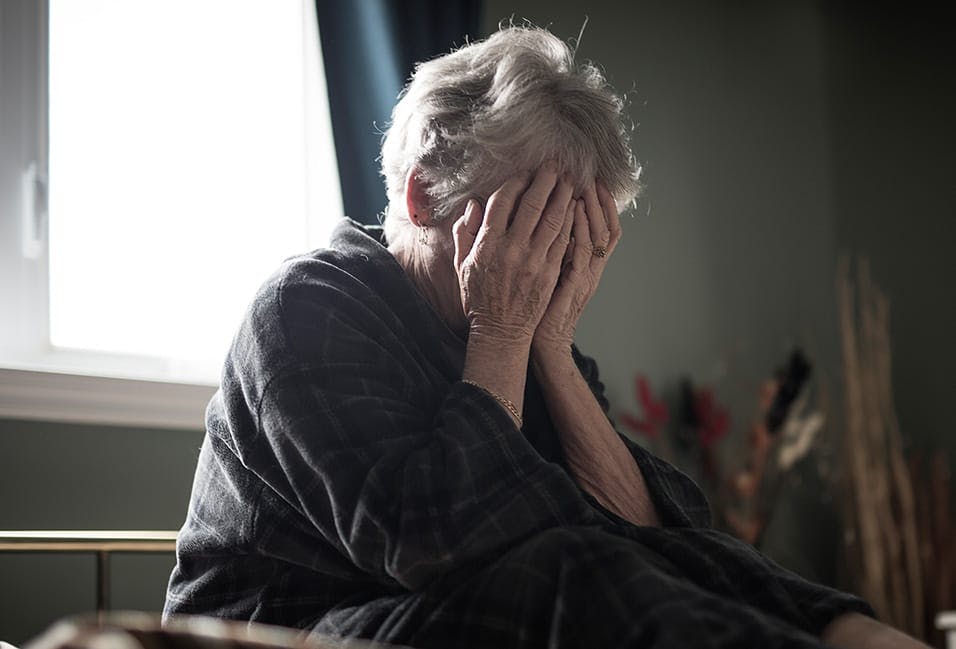 upset woman holding her hands over her face