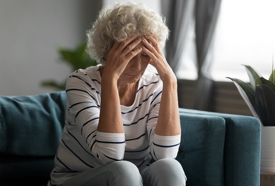 Upset woman with hands on her head