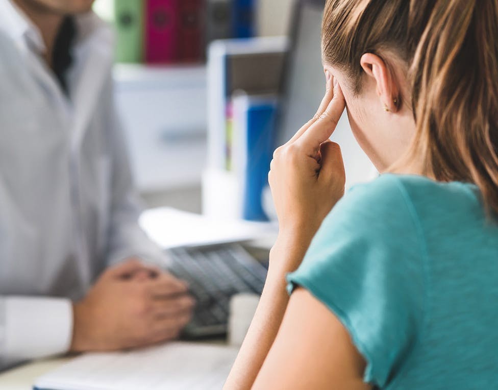 Woman touching her head in pain