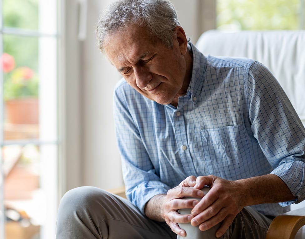 man holding his knee