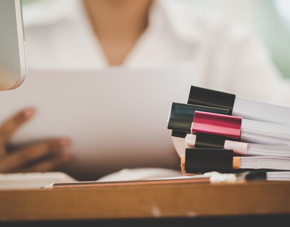 stack of papers clipped together with a binder clip