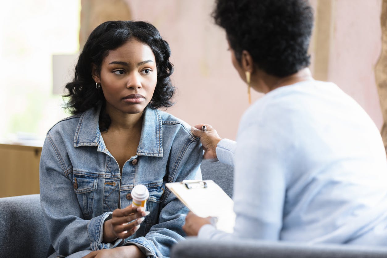 Sad woman being consoled by doctor