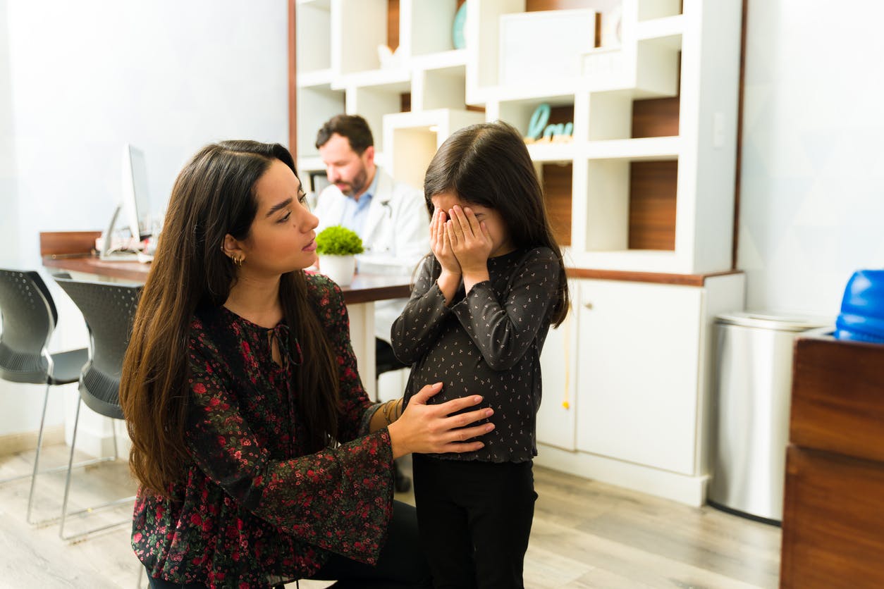 Mom consoling her crying daughter