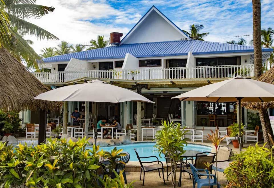 A beautiful beach resort in Fiji with palm trees and turquoise water, reportedly where Tiffany and Tim holidayed together