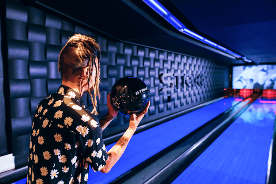 Man preparing to release bowling ball onto the lanes