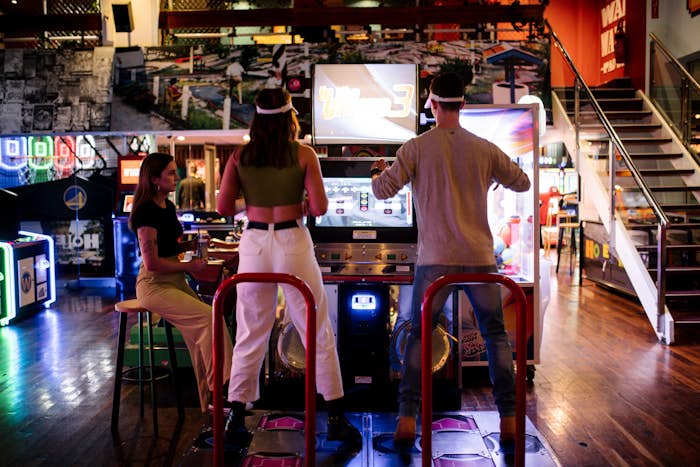 Man and woman playing Dancing arcade game