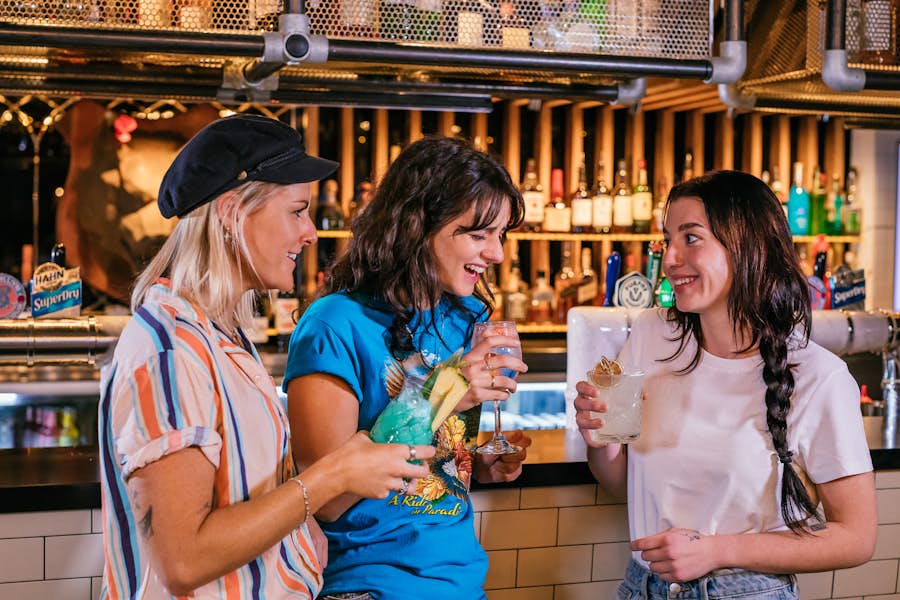Three women drinking at the Strike bar