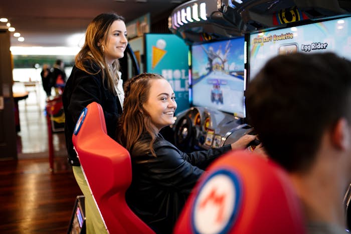 Girl playing driving arcade game
