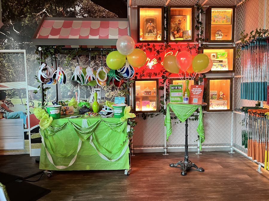 Holey Moley Pro Shop decorated in green to celebrate Day of Fun