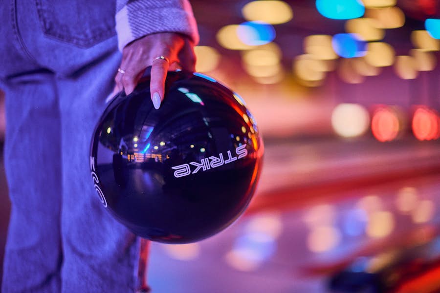 Close up of woman holding a Strike bowling ball