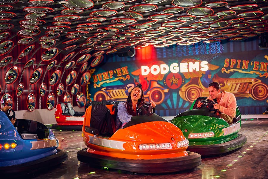 Group of people riding in bumper cars