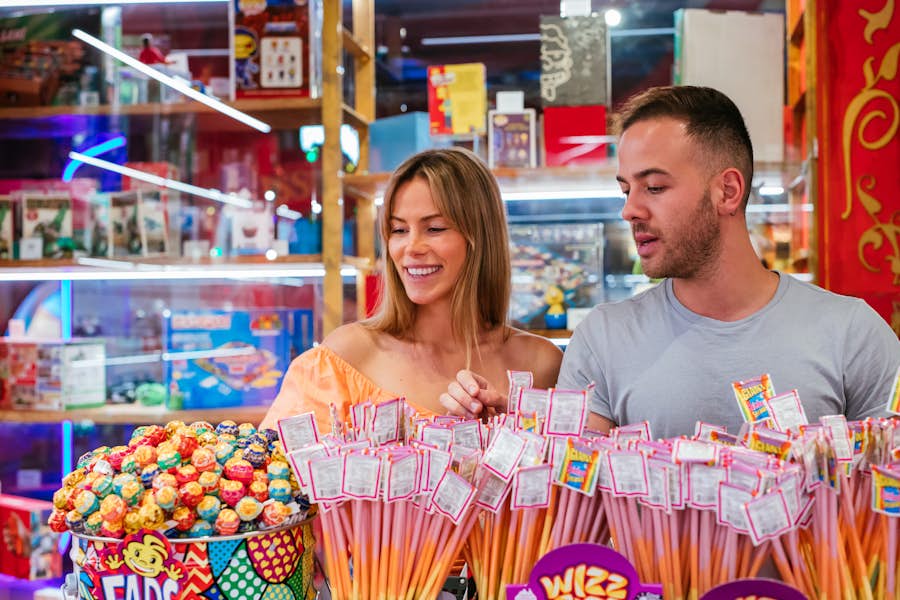 Man and woman looking through candy available in the prize redemption area