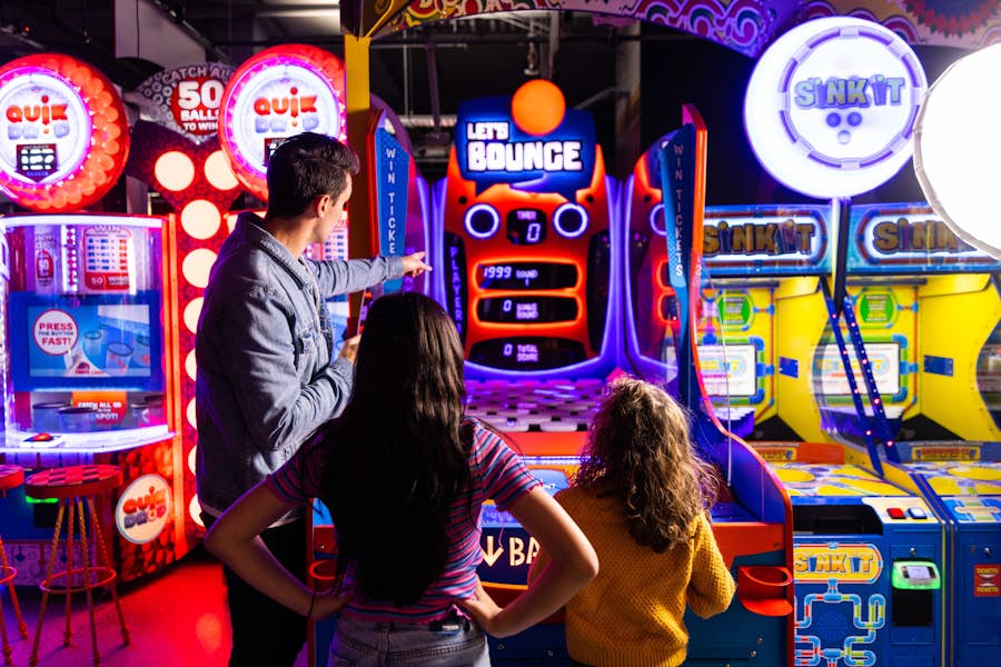 Family group playing arcade game lets bounce together