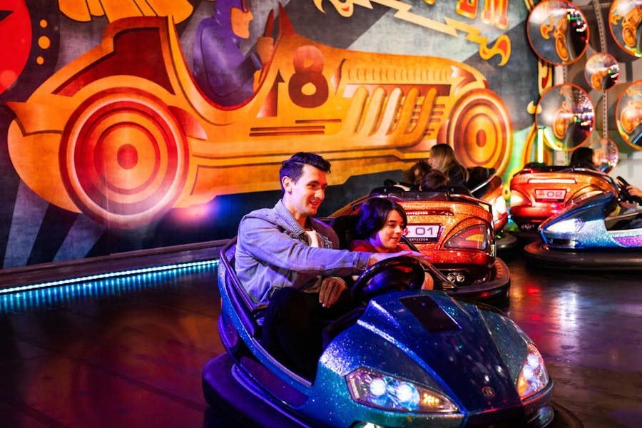 Father and son riding in a bumper car