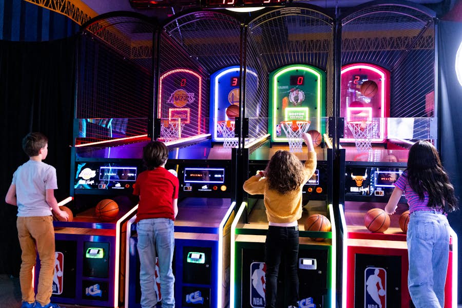 Group of kids playing NBA Hoops arcade game