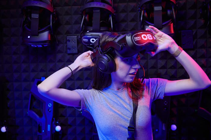 Girl putting on Zero Latency Virtual Reality goggles