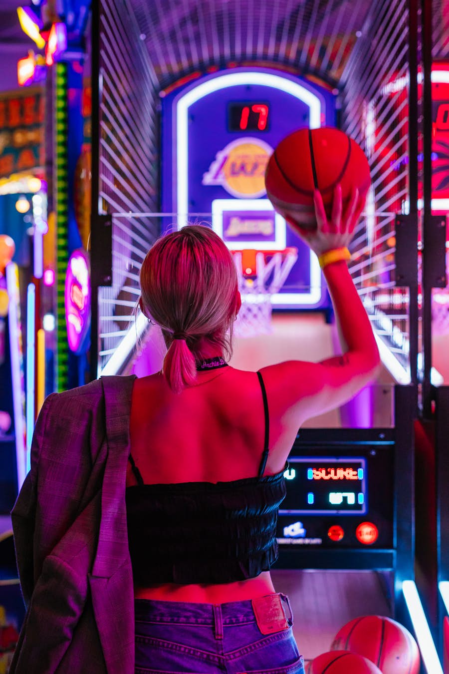 Woman playing NBA Hoops arcade game