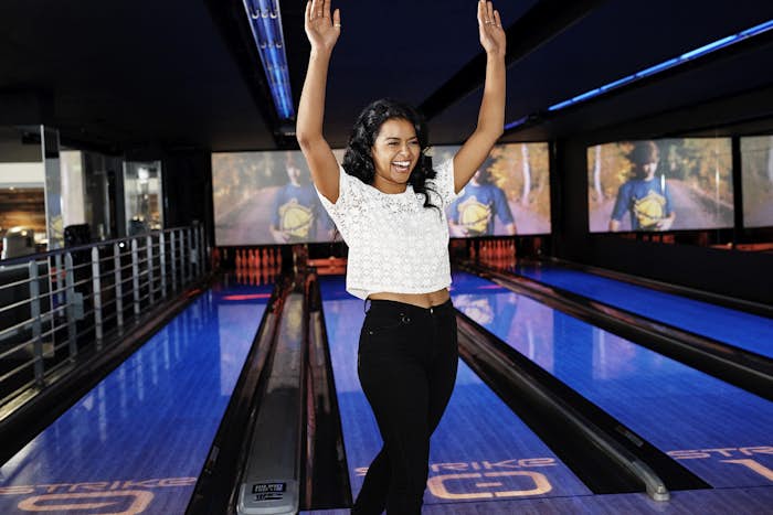 Woman celebrating on bowling lanes