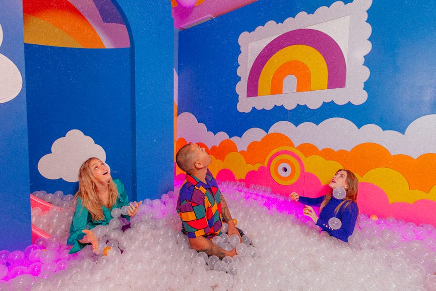 3 adults in a ball pit