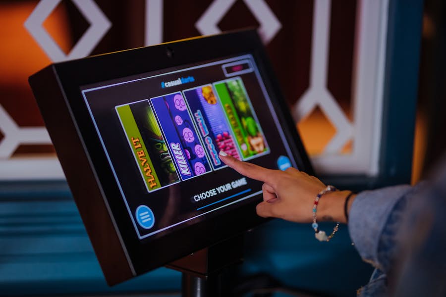 Person using a tablet to select a dart game to play