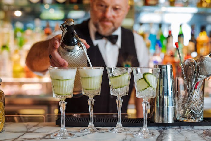 Bartender pouring cocktails behind the bar
