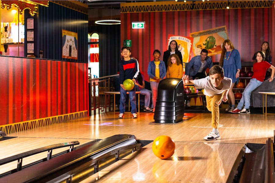 Young boy bowling at Archie Brothers