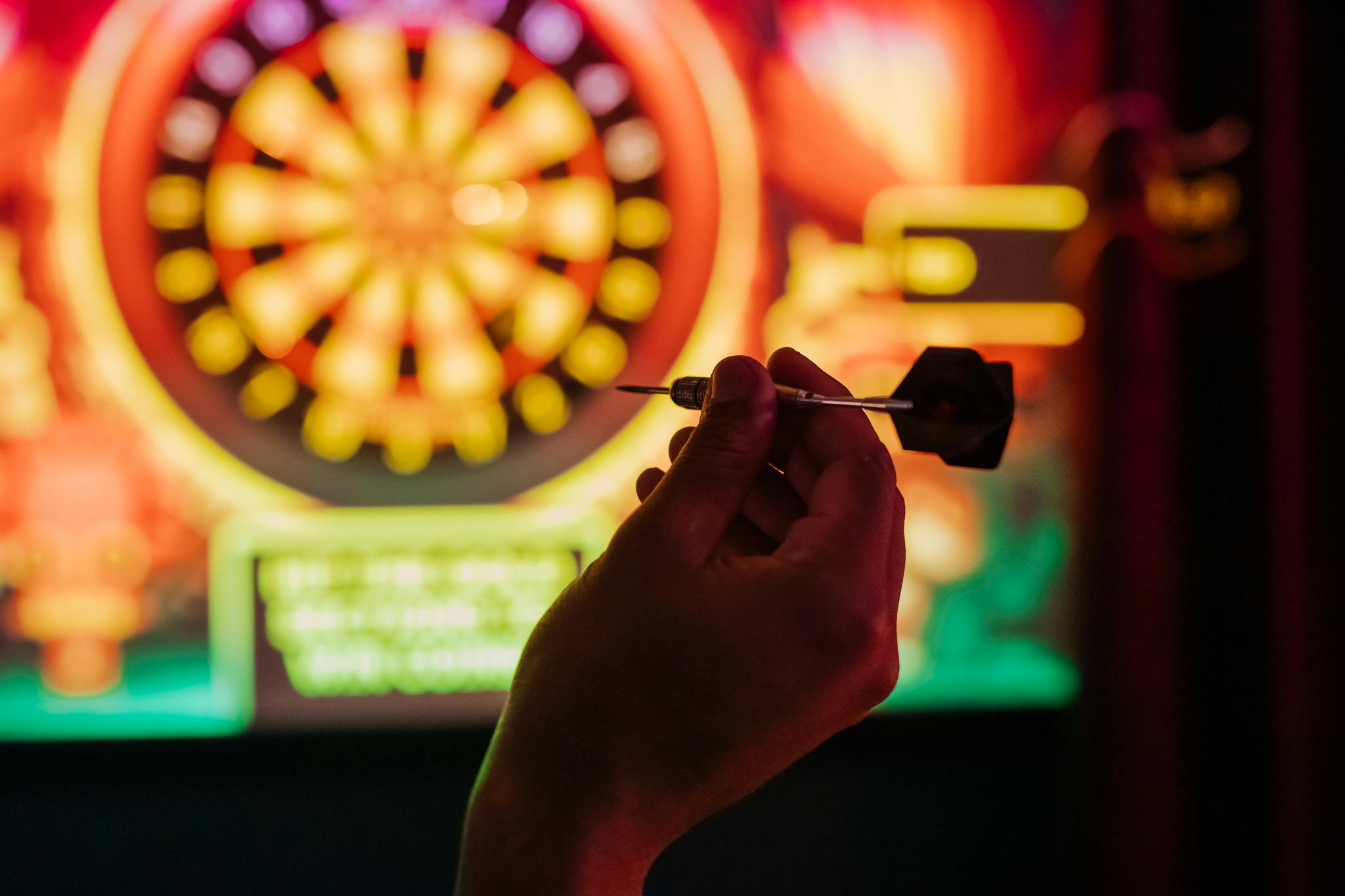 Dart being held in foreground with augmented oche in background