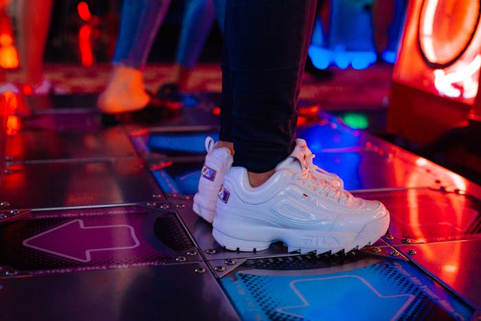 Close up of shoes of person playing Dance Dance Revolution